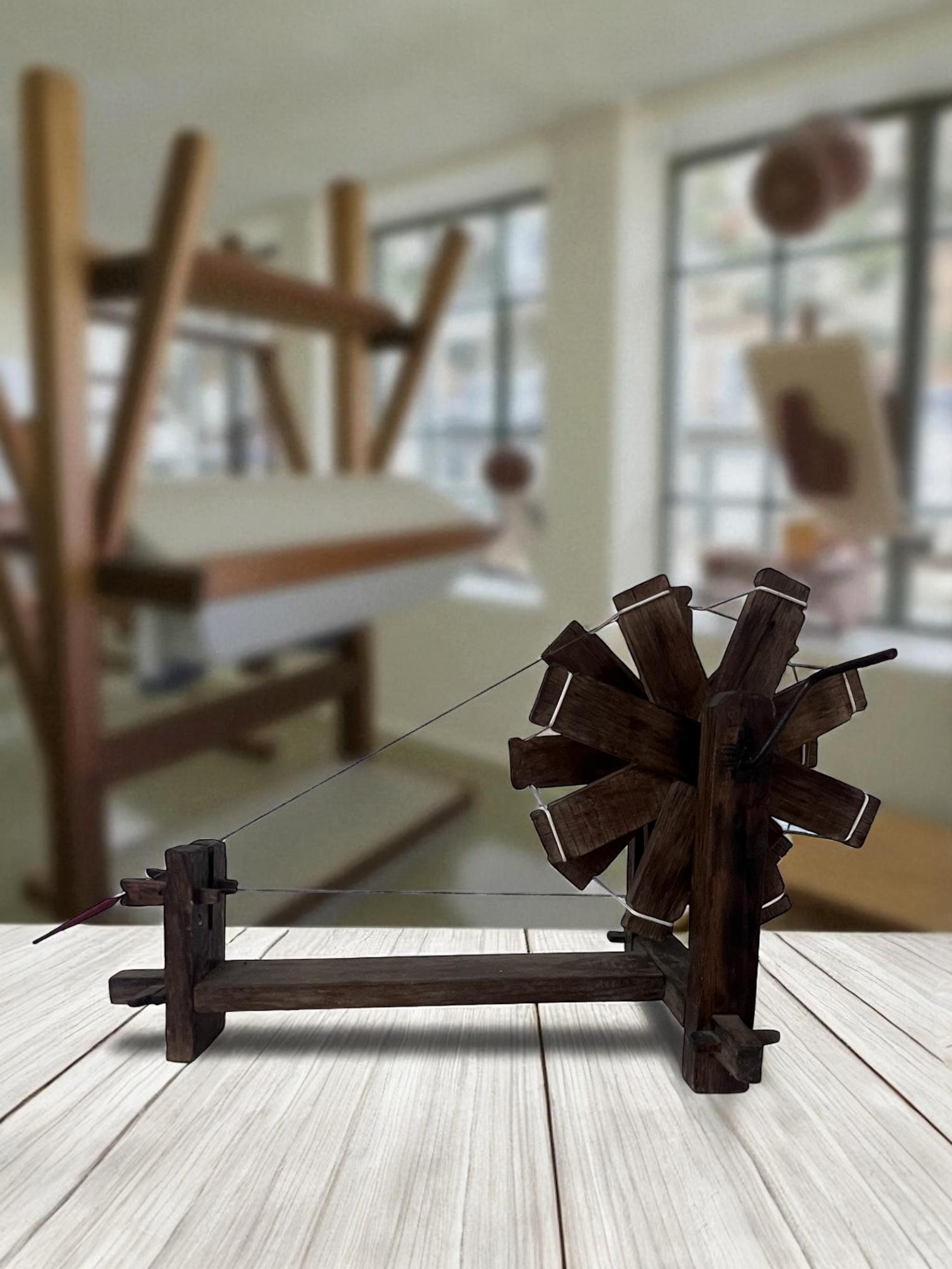 A traditional spinning wheel, representing textile heritage